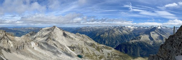 Panorama photo taken in Austria. It shows a clear sky with mountains.