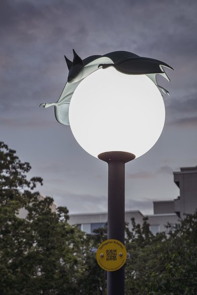A bat figure on a round lamp.