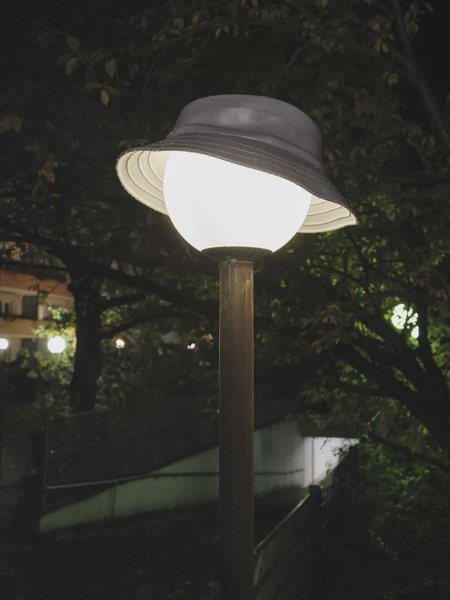 A hat on a round lamp.